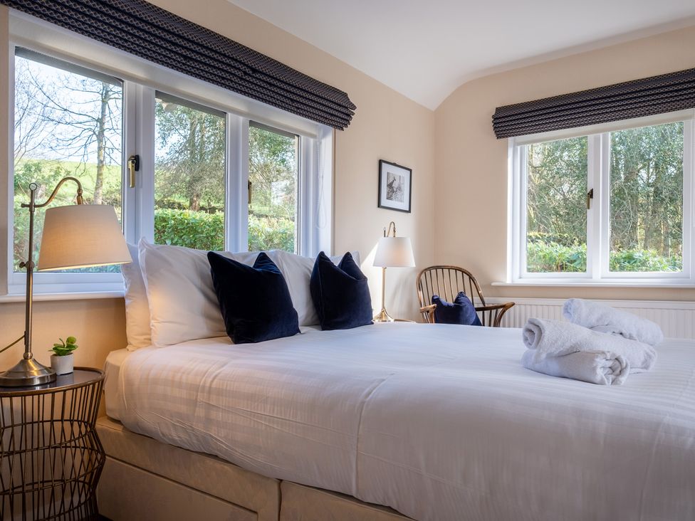 A bedroom with a bed and lamp at Marina View in Bowness-On-Windermere