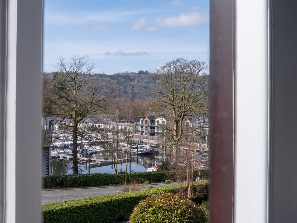 A view of a marina with boats and buildings at Marina View in Bowness-On-Windermere