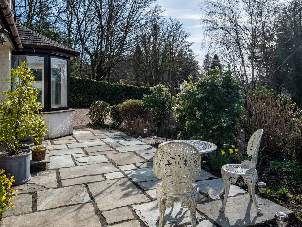 A patio area with a table and chairs at Marina View in Bowness-On-Windermere