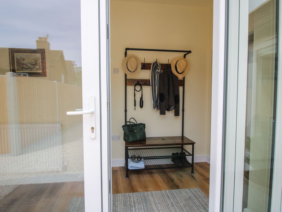 An entryway with a coat rack and bench at The Old Piggery in Shifnal