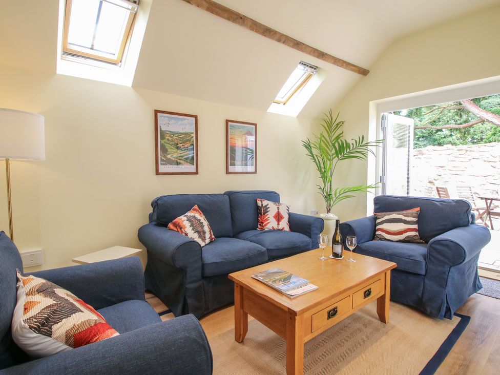 A living room with a coffee table and sofas at Old Piggery in Shifnal