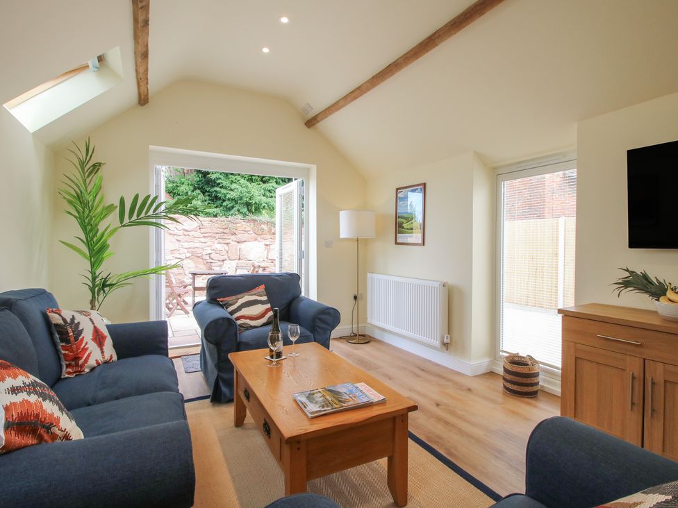 A living room with a sofa and coffee table at Old Piggery in Shifnal