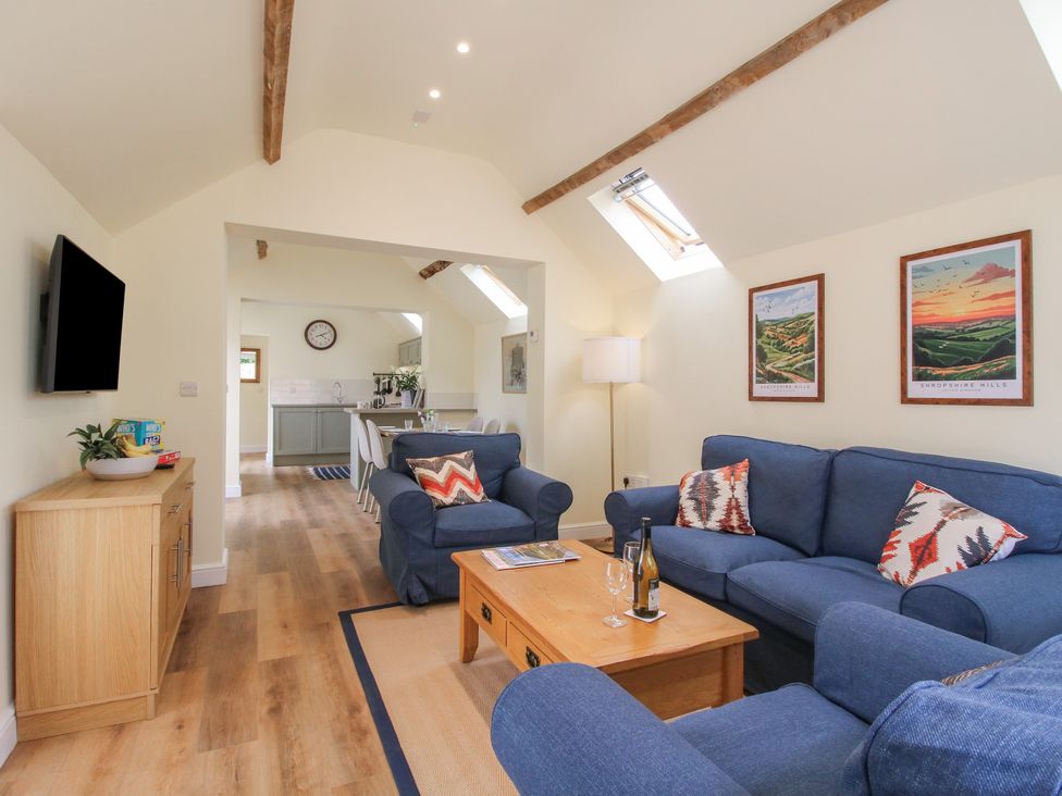 A living room with a sofa and coffee table at The Old Piggery in Shifnal