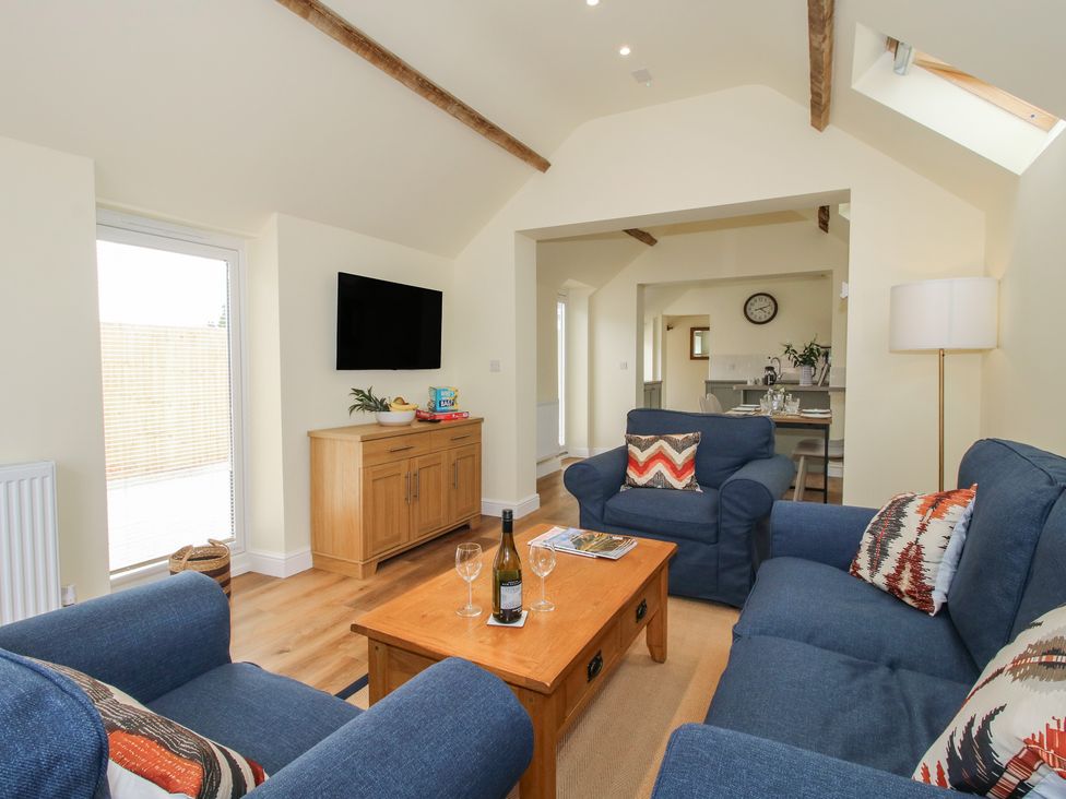A living room with a sofa and television at The Old Piggery in Shifnal