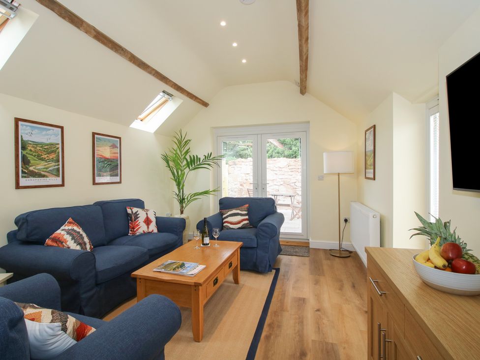 A living room with a sofa and coffee table at The Old Piggery in Shifnal