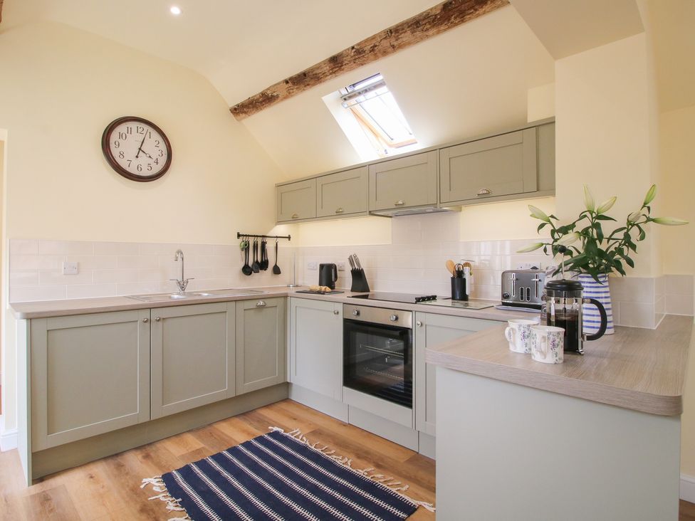 A kitchen with cabinets and appliances at Old Piggery in Shifnal