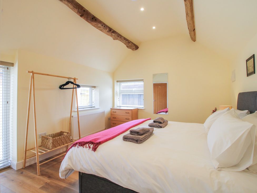 A bedroom with a bed and furniture at The Old Piggery in Shifnal