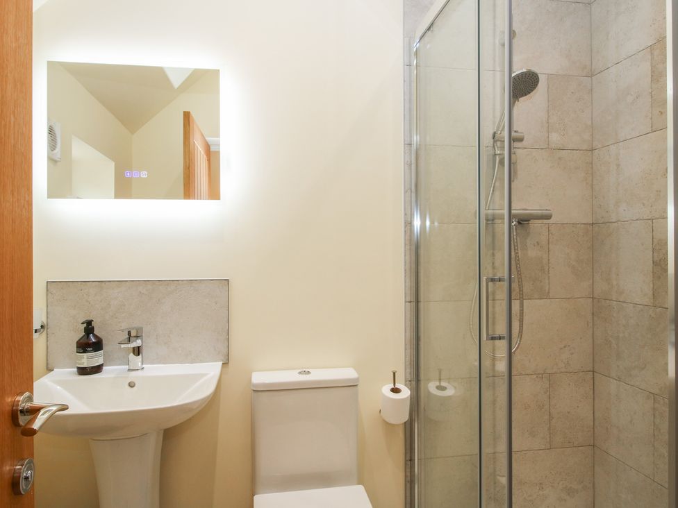 A bathroom with a shower and sink at The Old Piggery in Shifnal