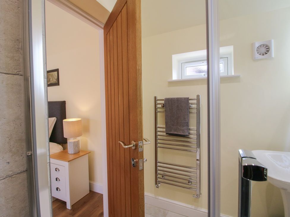 A bathroom with a towel rail and a sink at Old Piggery in Shifnal