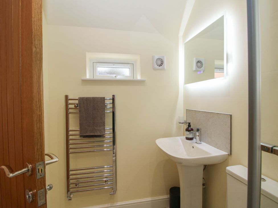 A bathroom with a sink and towel rack at The Old Piggery in Shifnal