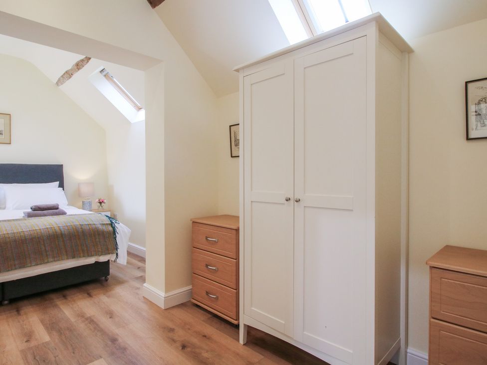 A bedroom with a bed and furniture at The Old Piggery in Shifnal