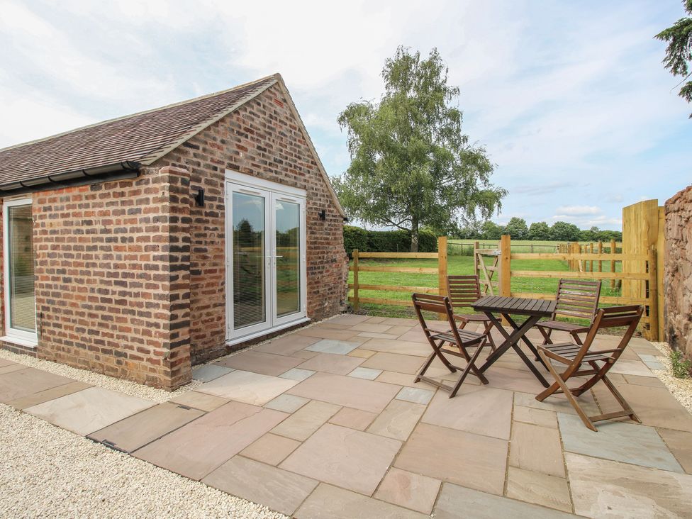 An outdoor patio with a table and chairs at The Old Piggery in Shifnal