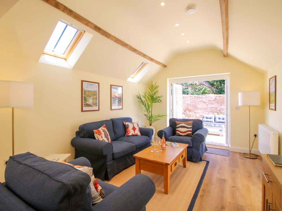 A living room with sofas and a coffee table at The Old Piggery in Ironbridge