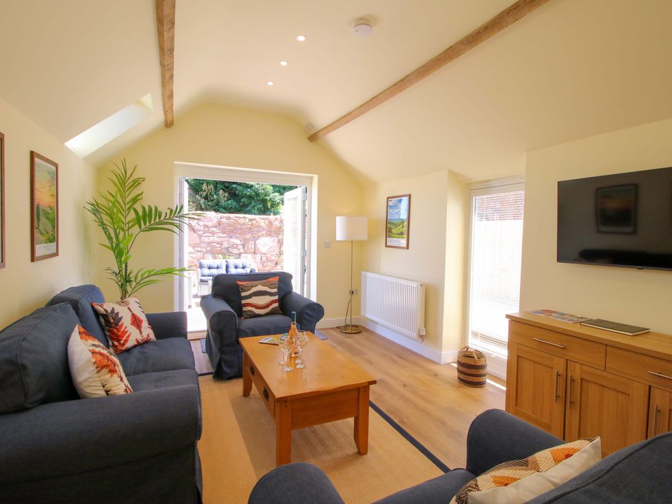 A living room with a sofa and coffee table at The Old Piggery in Ironbridge
