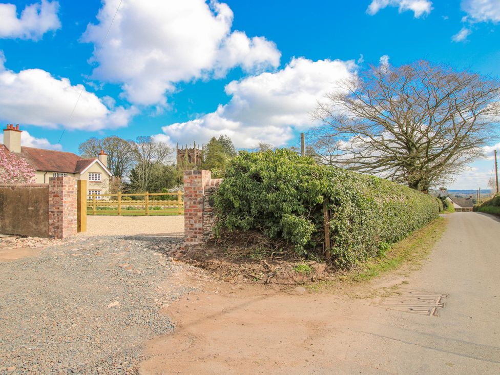 An outdoor view of a house with a gate and road at The Old Piggery in Ironbridge