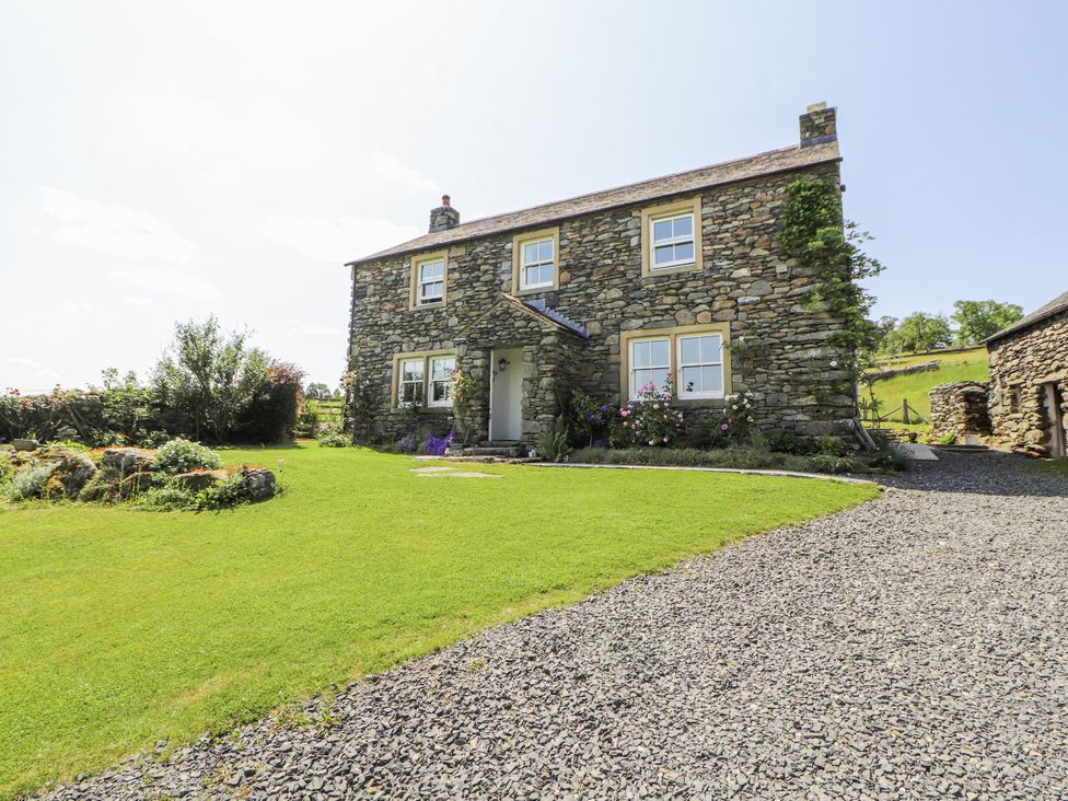 A stone house with garden and gravel path at High Wood Foot in Bampton, Cumbria