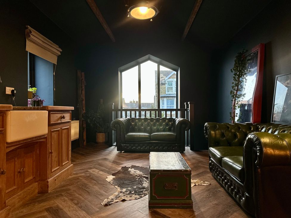 A living room with sofas and a coffee table at The Balmoral Coach House in Morecambe