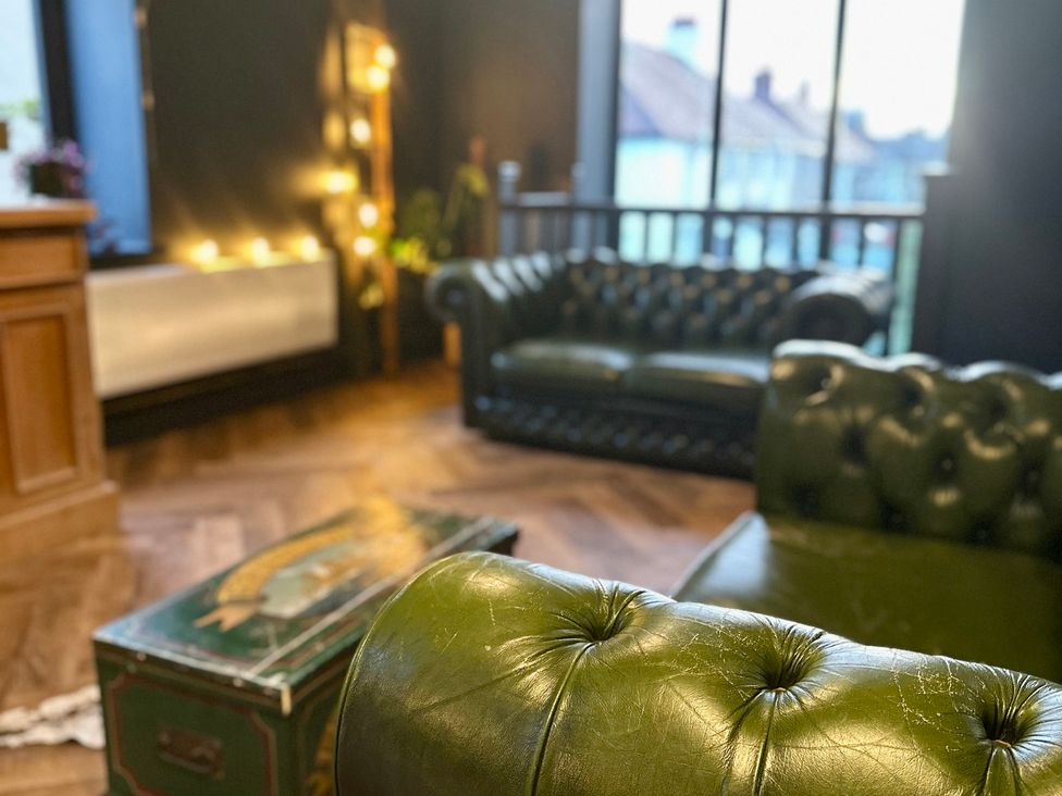 A living room with sofas and a coffee table at The Balmoral Coach House in Morecambe
