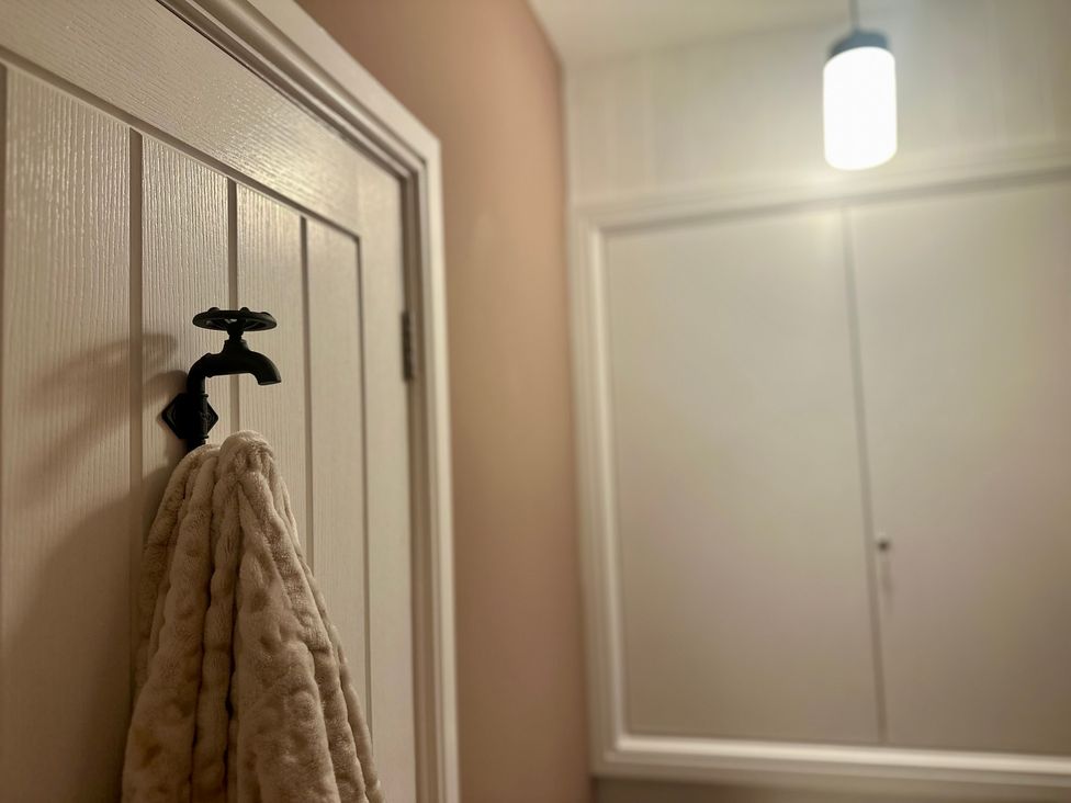 A bathroom with a towel hanging on a rack at The Balmoral Coach House in Morecambe