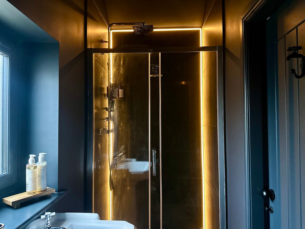 A bathroom with a shower and sink at The Balmoral Coach House in Morecambe