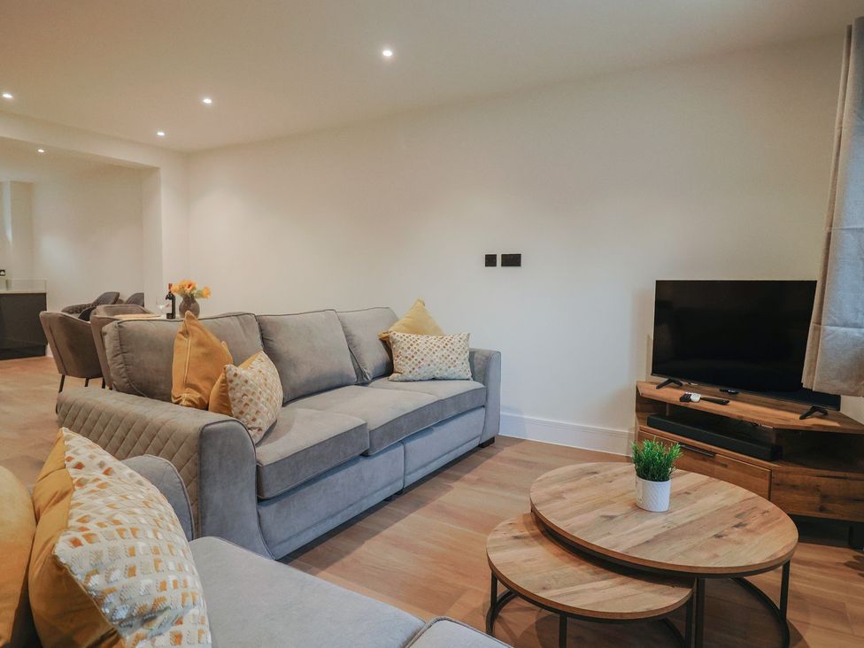 A living room with a sofa and television at Oak lodge Westonzoyland nr. Bridgwater