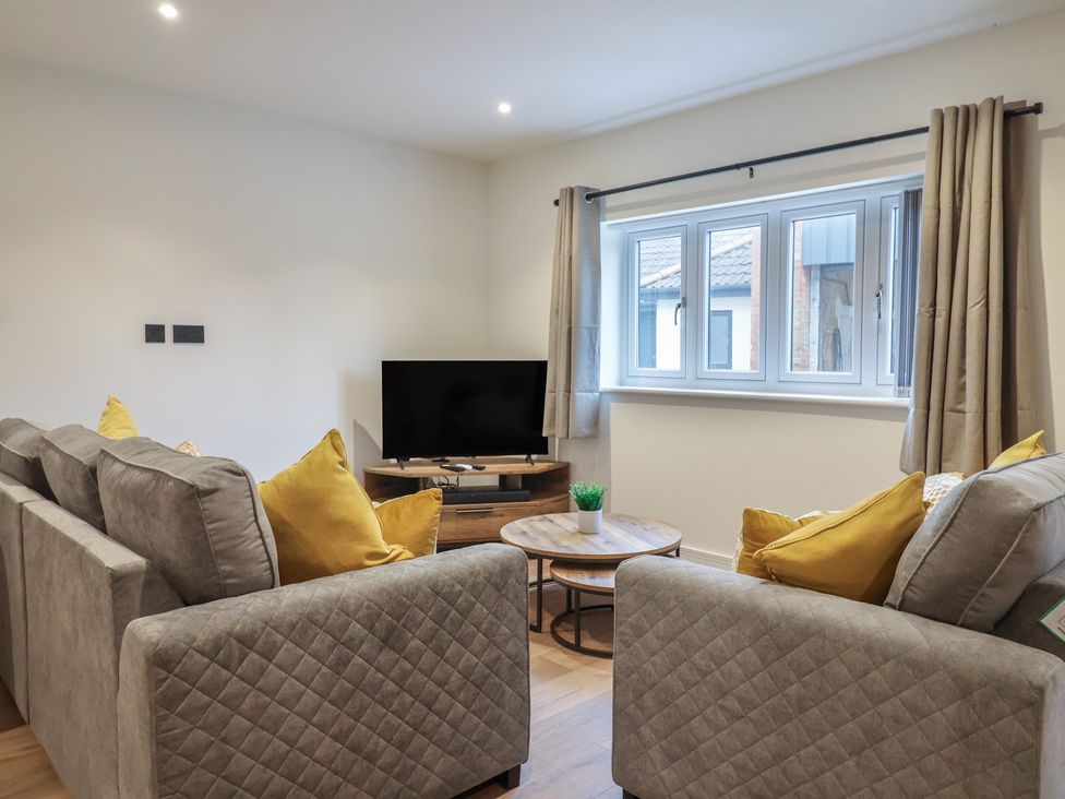 A living room with sofa and television at Oak lodge Westonzoyland nr. Bridgwater