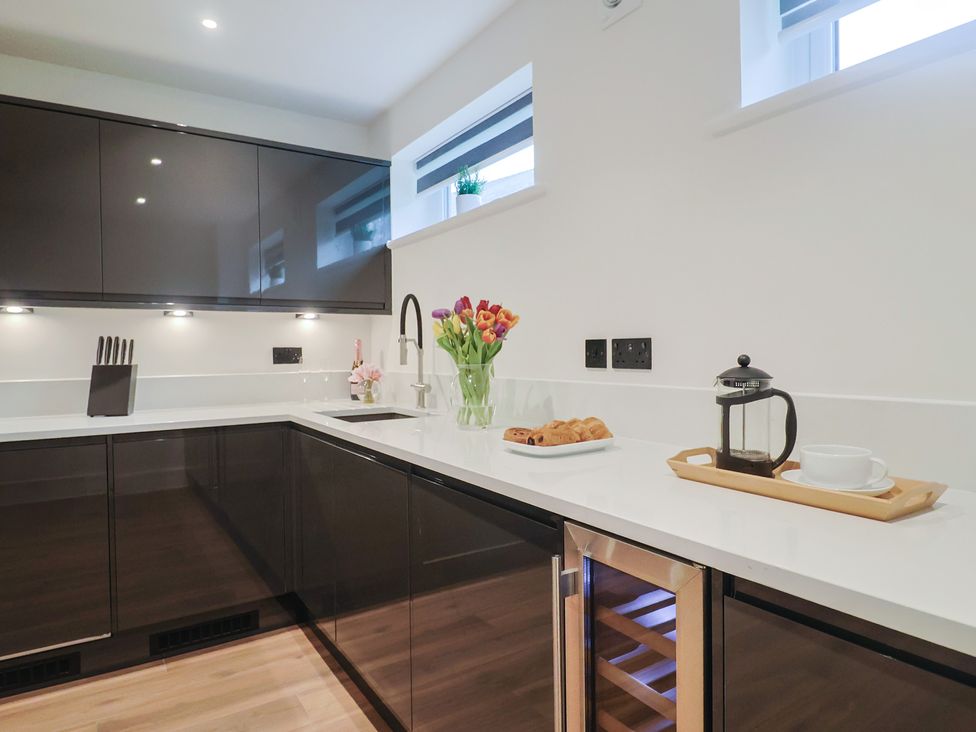 A kitchen with sink and modern cabinets at Oak lodge Westonzoyland nr. Bridgwater