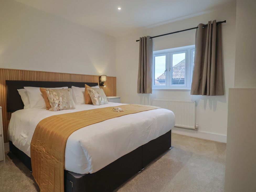 A bedroom with a bed and two pillows at Oak lodge Westonzoyland nr. Bridgwater