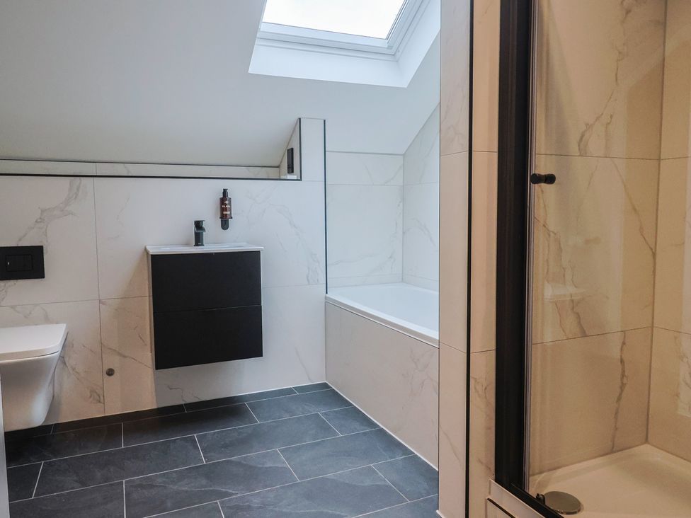 A bathroom with a bathtub and a shower at Oak lodge Westonzoyland nr. Bridgwater