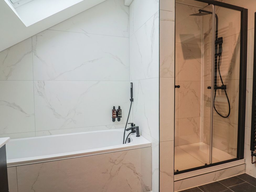 A bathroom with a bathtub and shower at Oak lodge Westonzoyland nr. Bridgwater