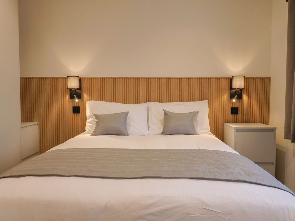 A bedroom with a bed and nightstands at Oak lodge in Westonzoyland nr. Bridgwater