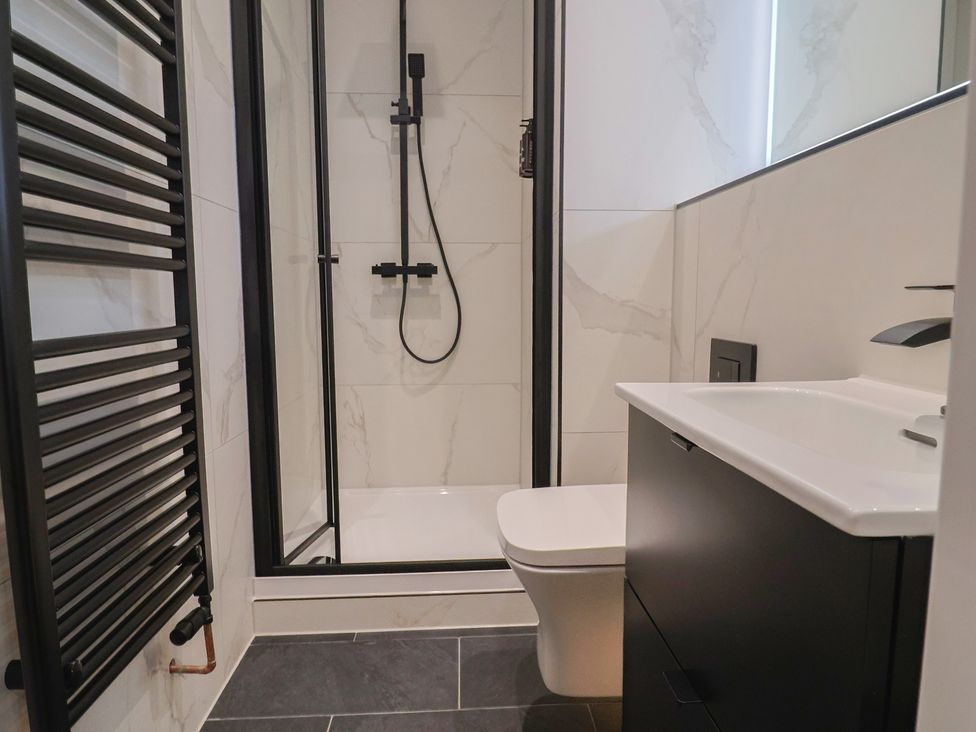 A bathroom with a shower, sink, and toilet at Oak lodge Westonzoyland nr. Bridgwater