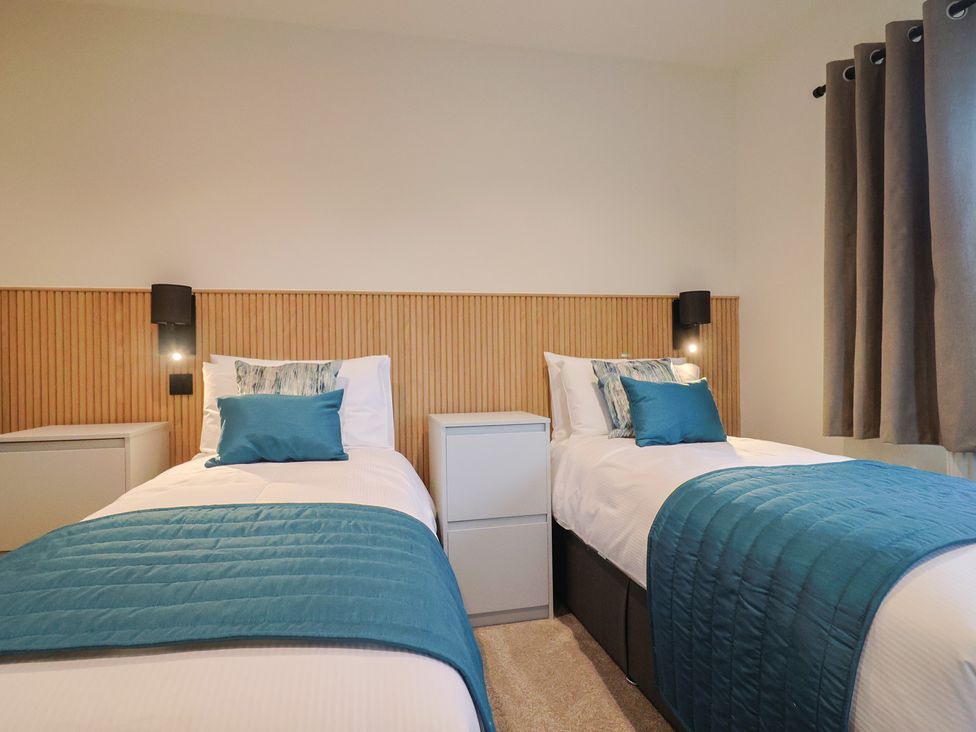 A bedroom with two single beds and bedside tables at Oak lodge Westonzoyland nr. Bridgwater