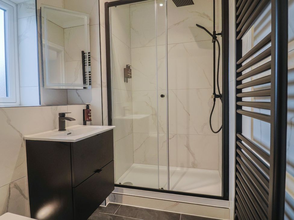 A bathroom with a shower and sink at Oak lodge Westonzoyland nr. Bridgwater