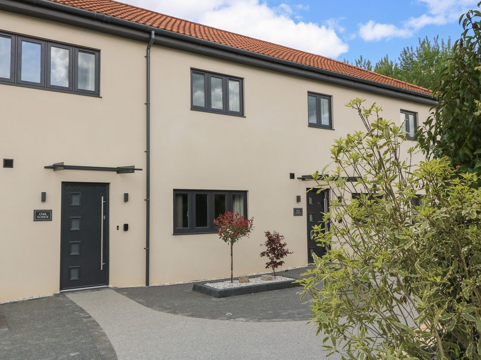 An exterior view of a house with front door and windows at Oak Lodge in Westonzoyland nr. Bridgwater