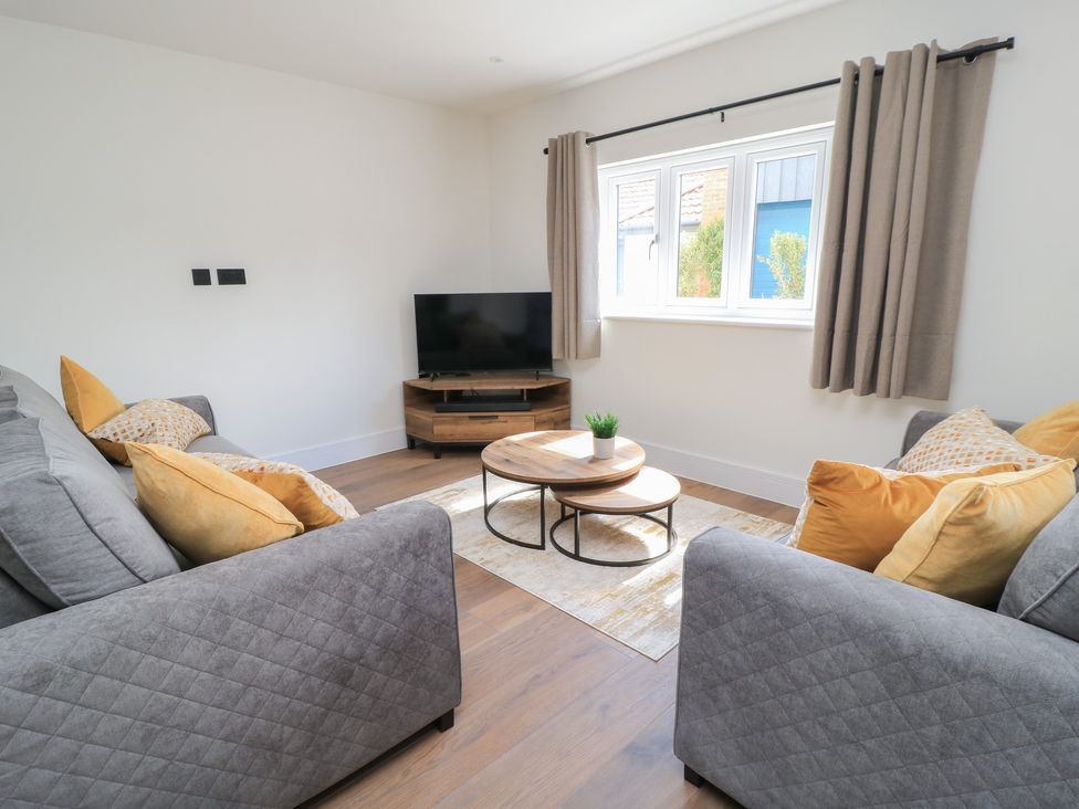 A living room with a sofa and TV at Oak Lodge, Westonzoyland nr. Bridgwater