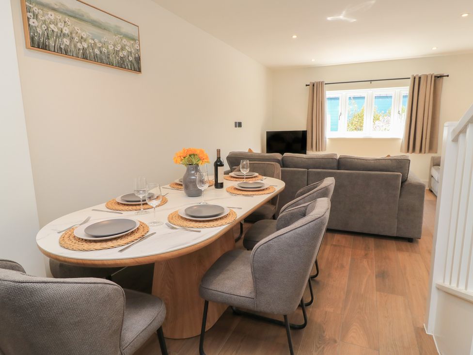 A dining room with a table set for dinner at Oak Lodge Westonzoyland nr. Bridgwater