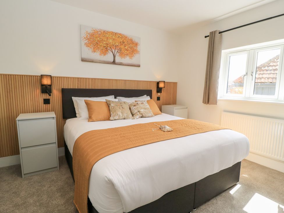 A bedroom with a bed and bedside tables at Oak Lodge Westonzoyland nr. Bridgwater