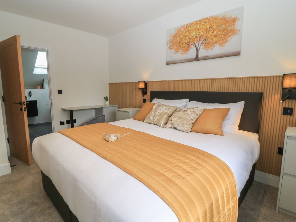 A bedroom with a bed and desk at Oak Lodge, Westonzoyland nr. Bridgwater