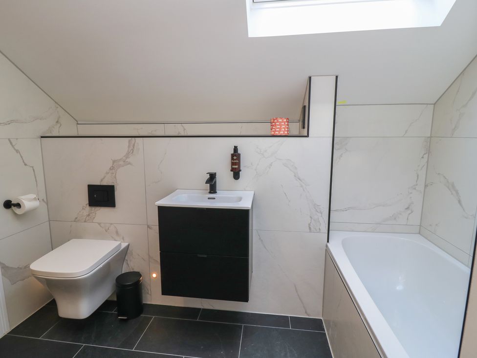 A bathroom with a sink and bathtub at Oak Lodge Westonzoyland nr. Bridgwater