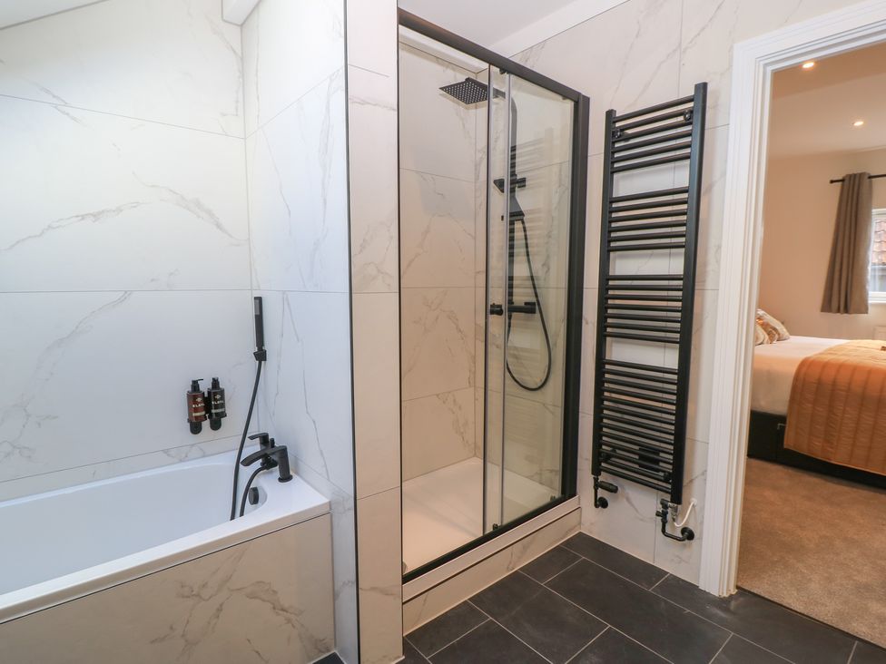 A bathroom with a shower and bathtub at Oak Lodge Westonzoyland nr. Bridgwater