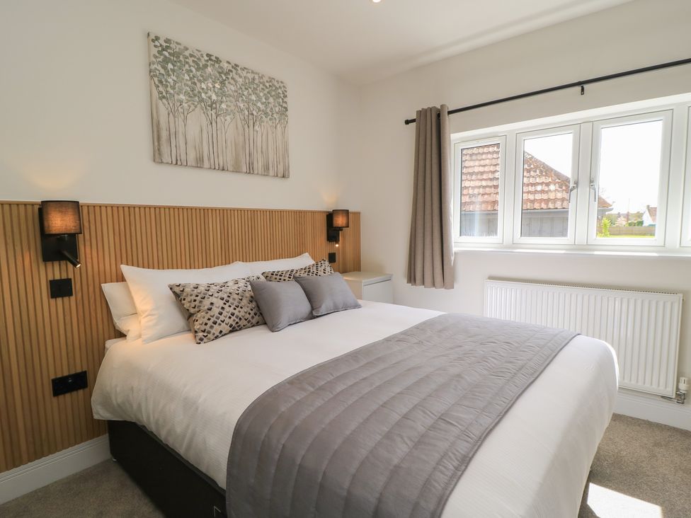 A bedroom with a bed and window at Oak Lodge in Westonzoyland nr. Bridgwater