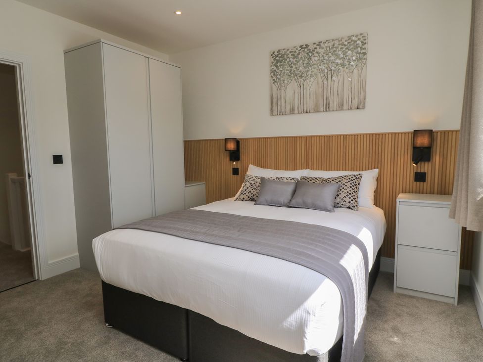 A bedroom with a bed and wardrobe at Oak Lodge Westonzoyland nr. Bridgwater