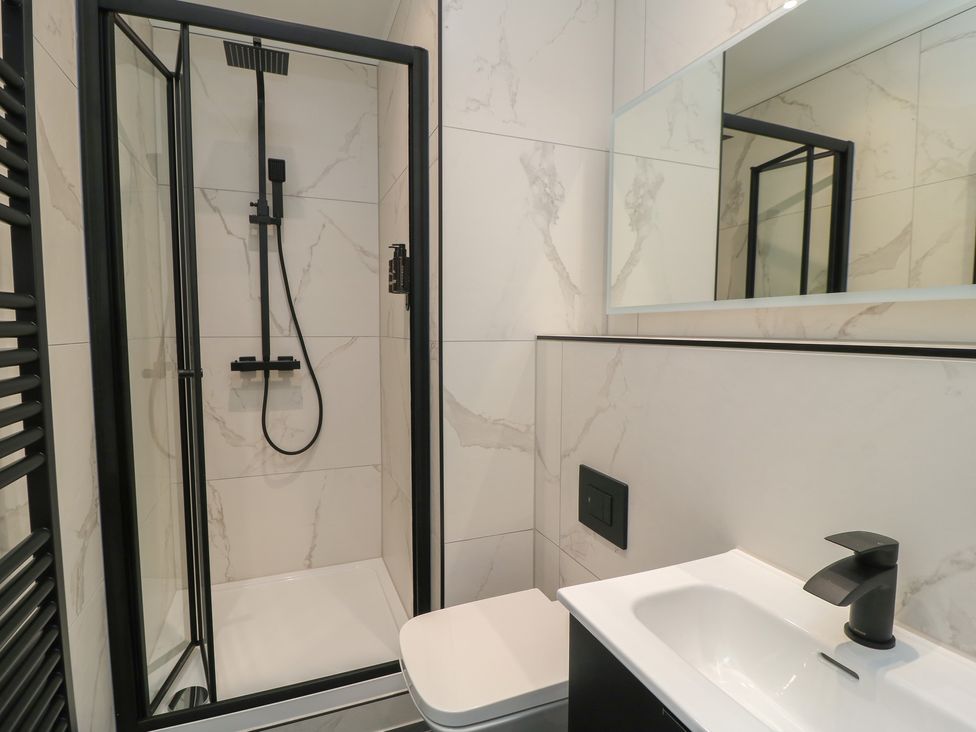 A bathroom with a shower, toilet, and sink at Oak Lodge in Westonzoyland nr. Bridgwater