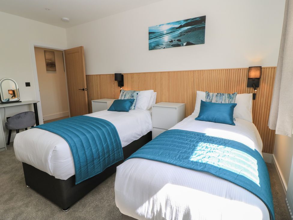 A bedroom with two beds and a desk at Oak Lodge Westonzoyland nr. Bridgwater