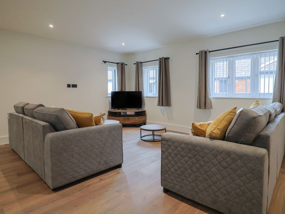 A living room with a sofa and a television at Pine Lodge Westonzoyland nr. Bridgwater