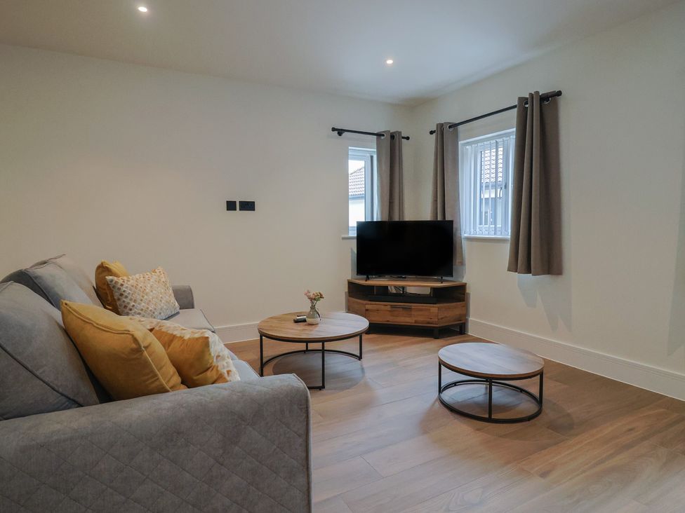 A living room with a sofa and coffee tables at Pine Lodge in Westonzoyland nr. Bridgwater