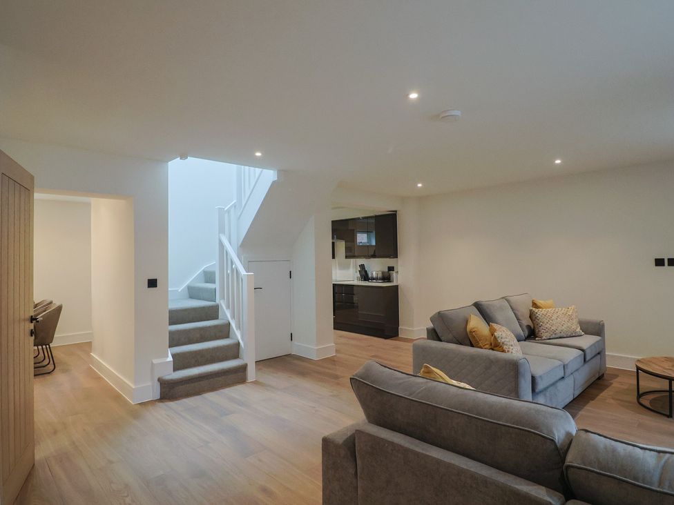 A living room featuring a sofa, coffee table, and stairs at Pine Lodge in Westonzoyland nr. Bridgwater