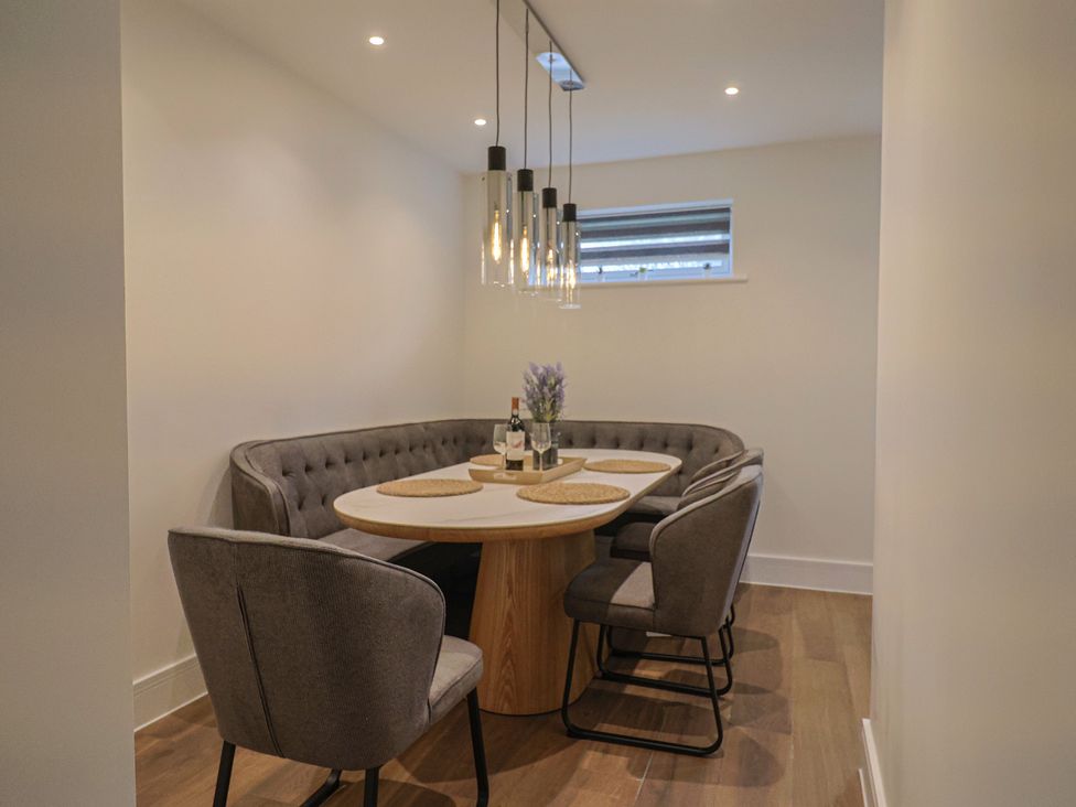 A dining room with a table and chairs at Pine Lodge in Westonzoyland nr. Bridgwater