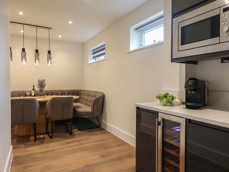 A kitchen with a dining table and chairs at Pine Lodge in Westonzoyland nr. Bridgwater